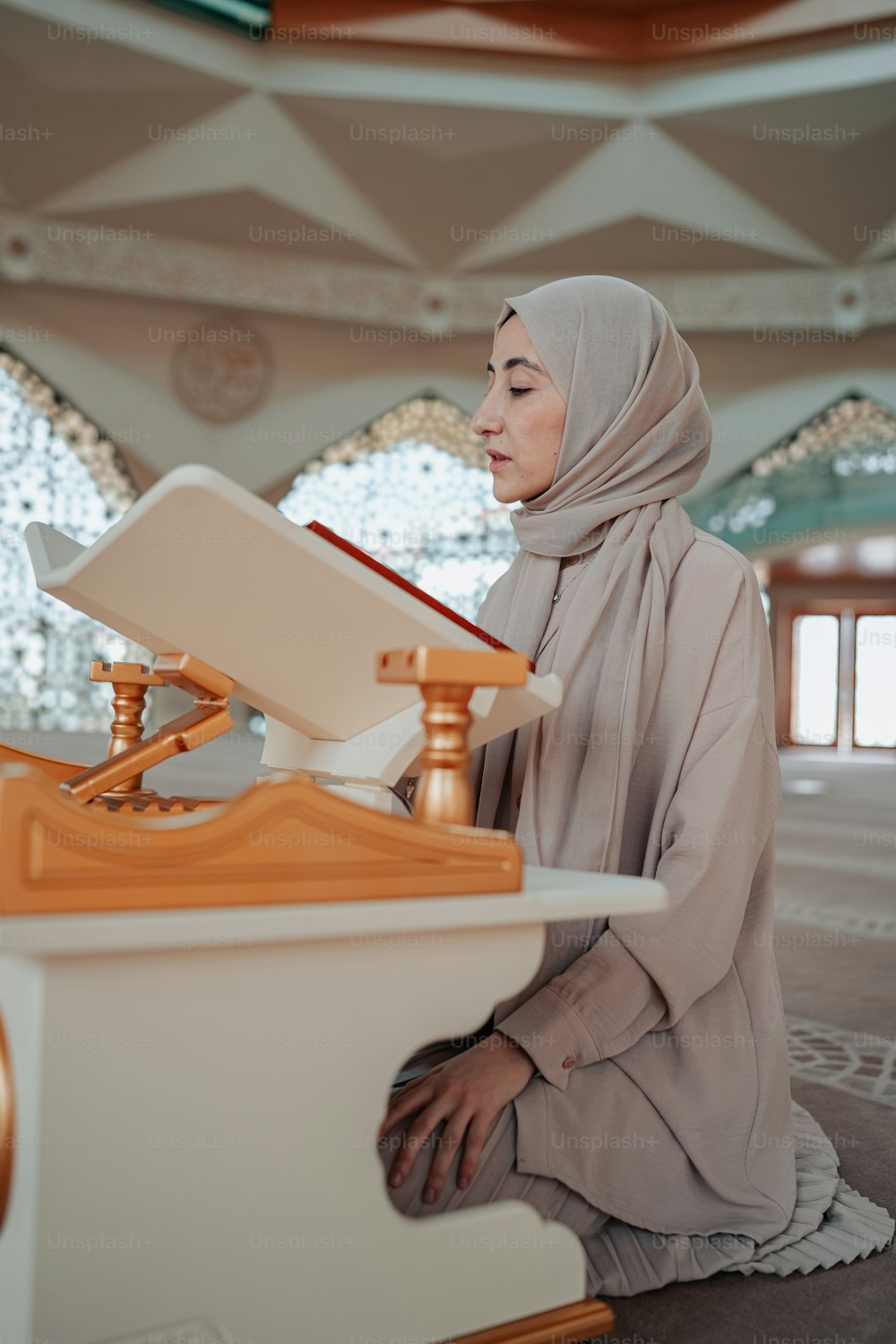 a woman in a hijab sitting on the floor