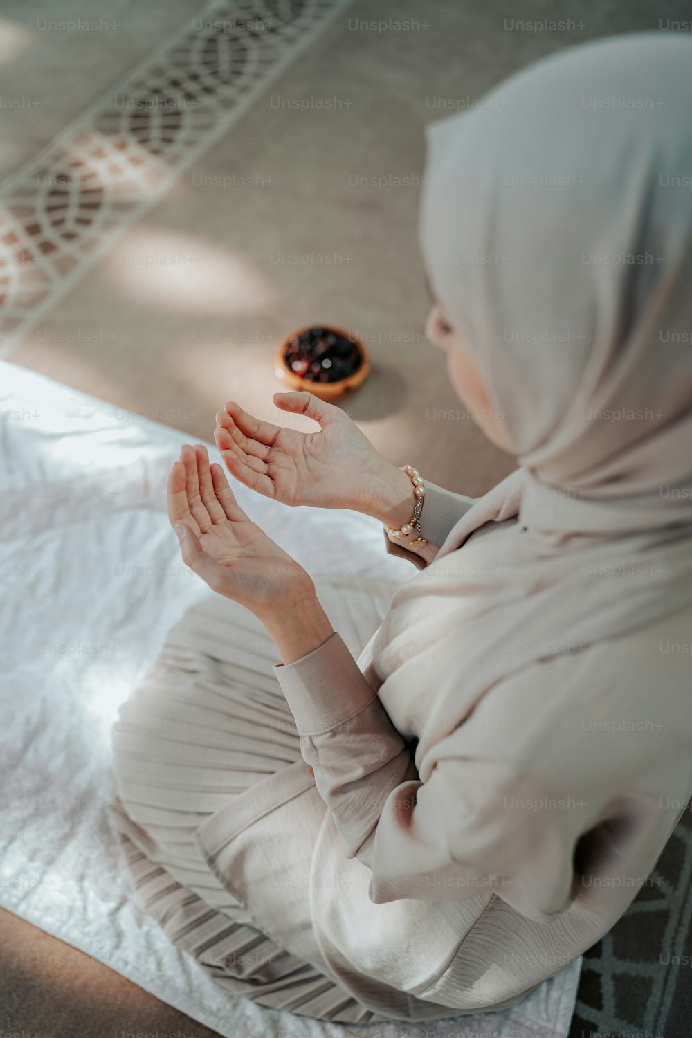 a woman in a hijab sitting on a bed
