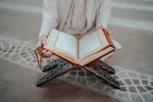 a person sitting on the ground holding a book