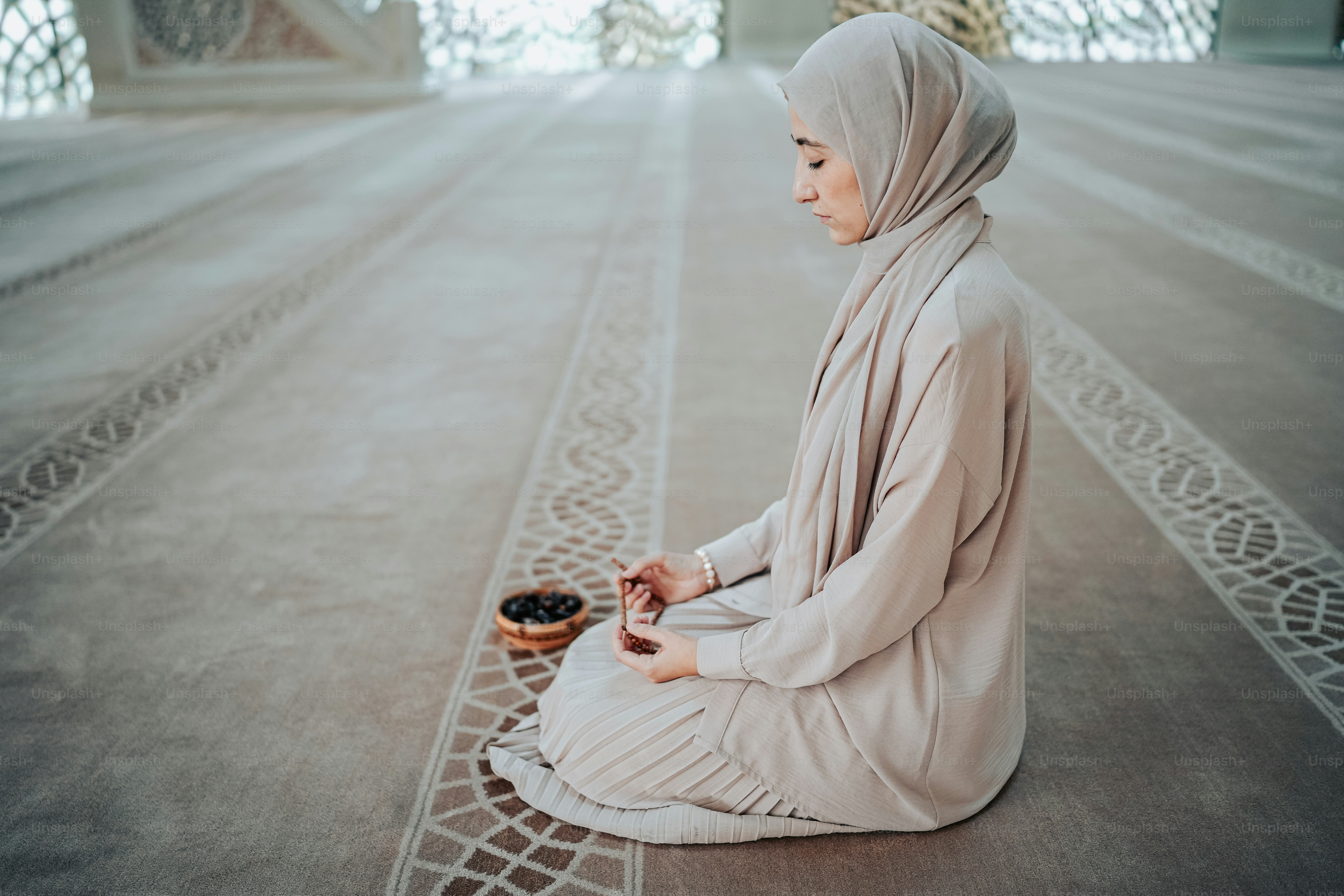 a woman sitting on the floor with a bowl of food