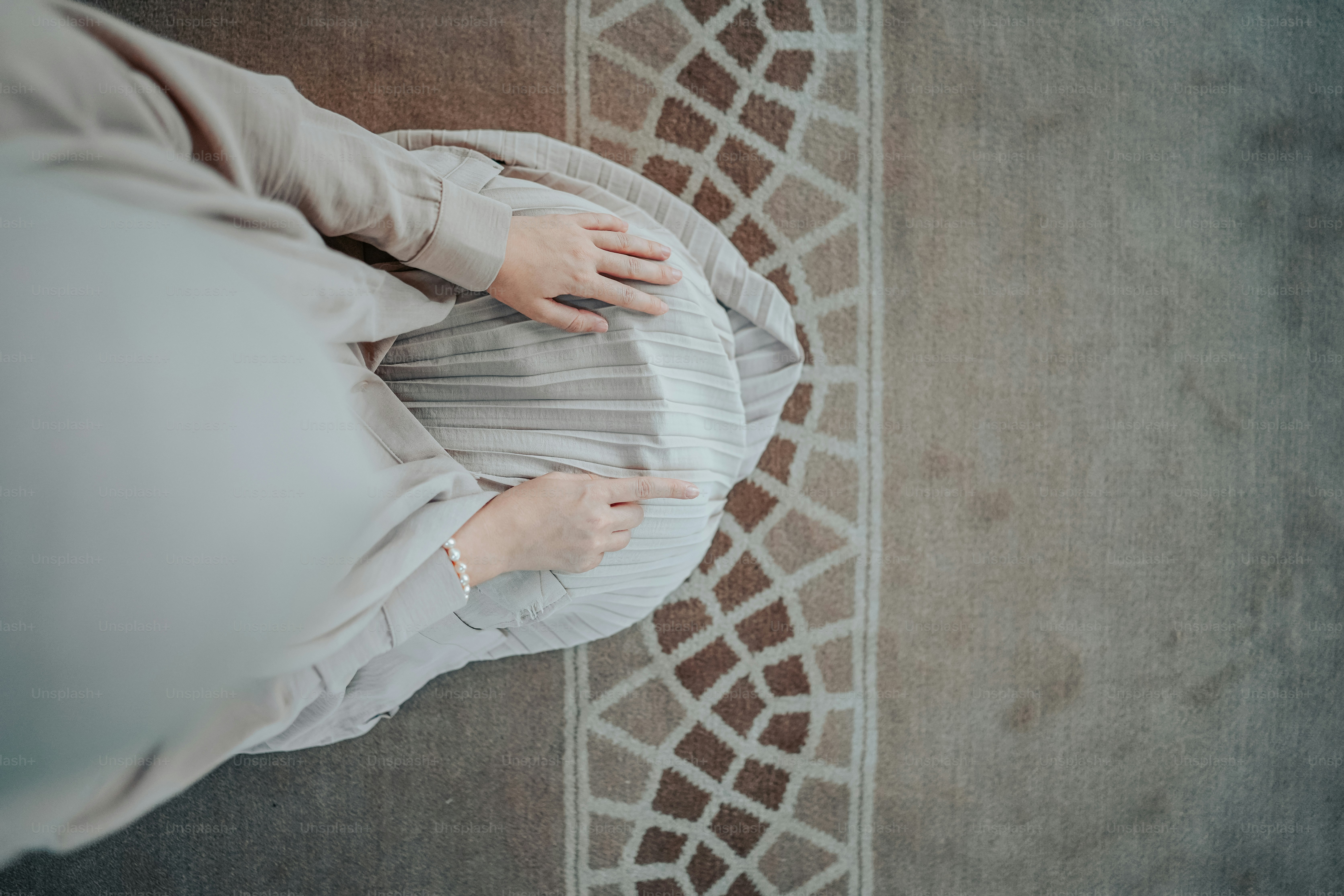 a woman in a white shirt is holding a pillow