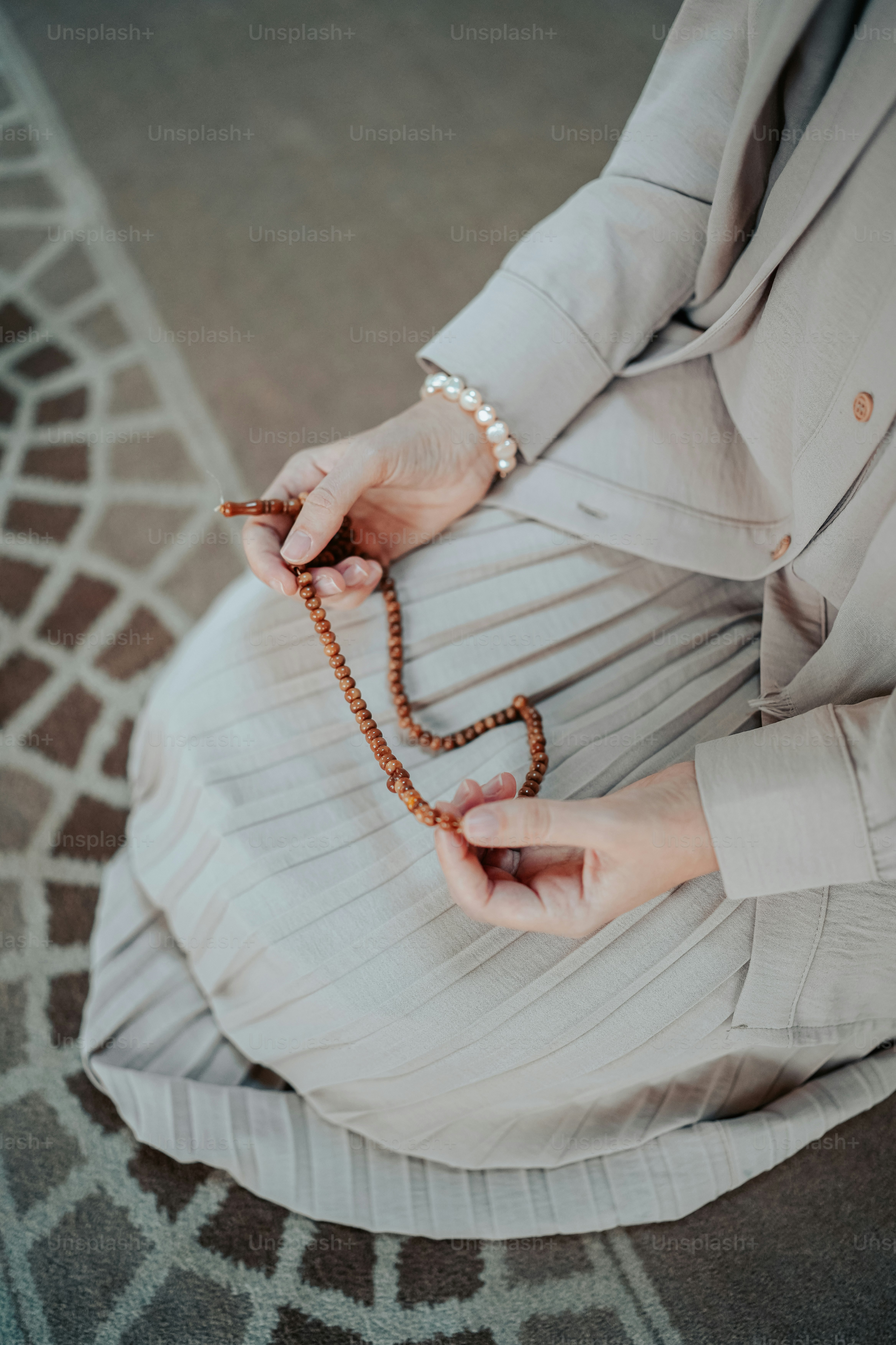 a woman is holding a rosary in her hands