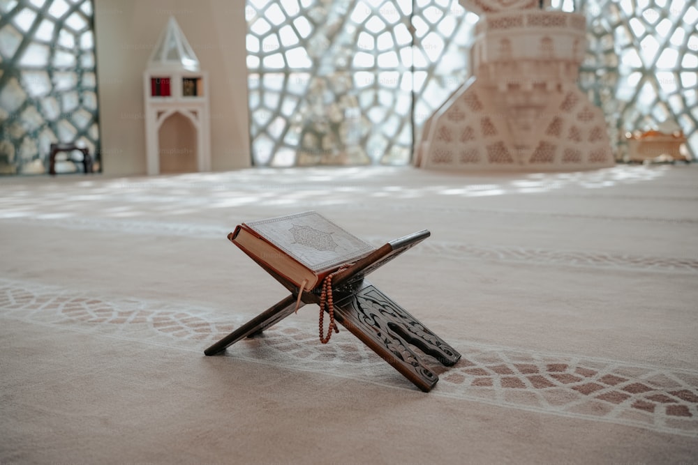 an open book sitting on top of a wooden cross