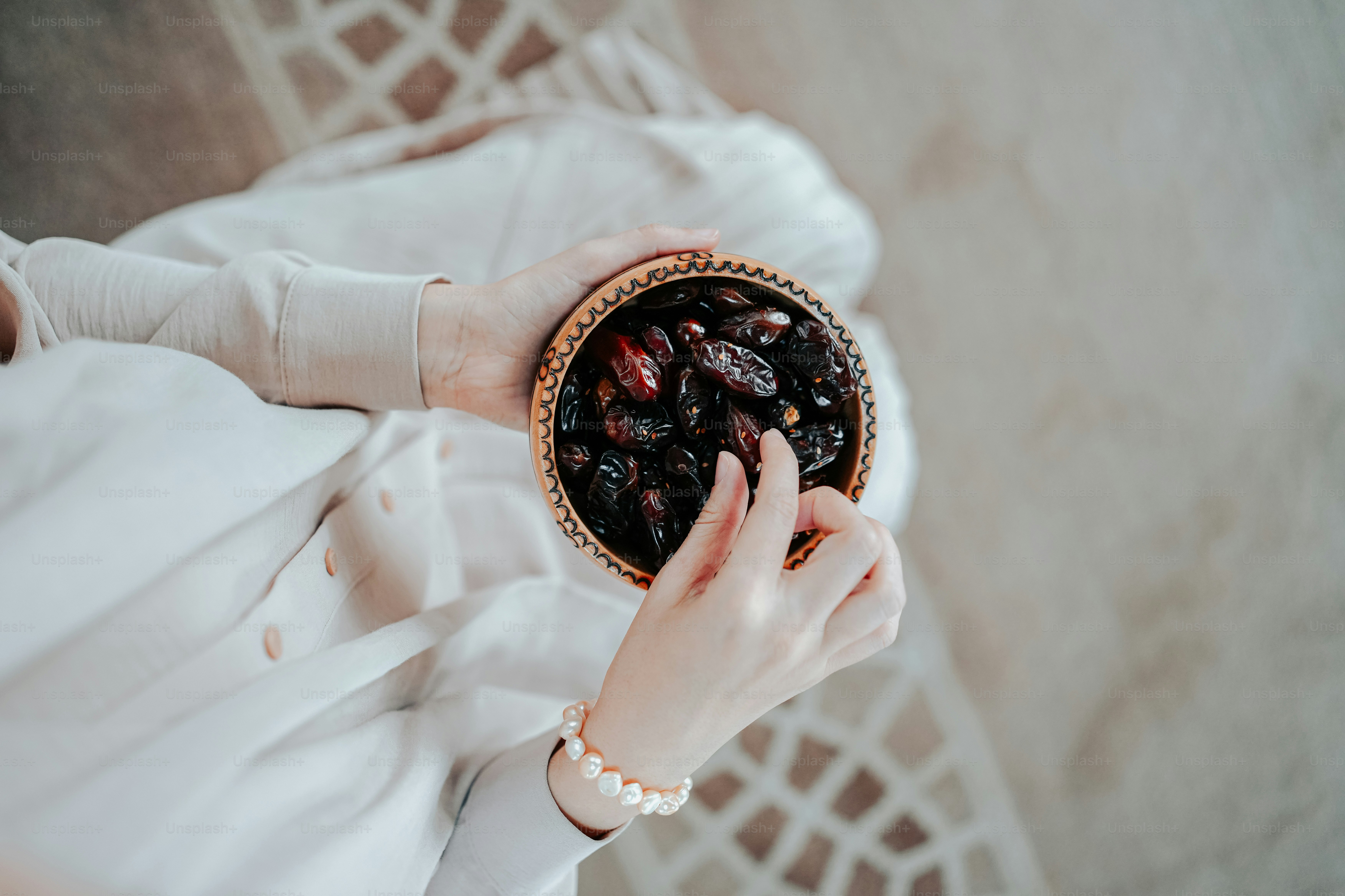 a woman holding a bowl of raisins in her hands