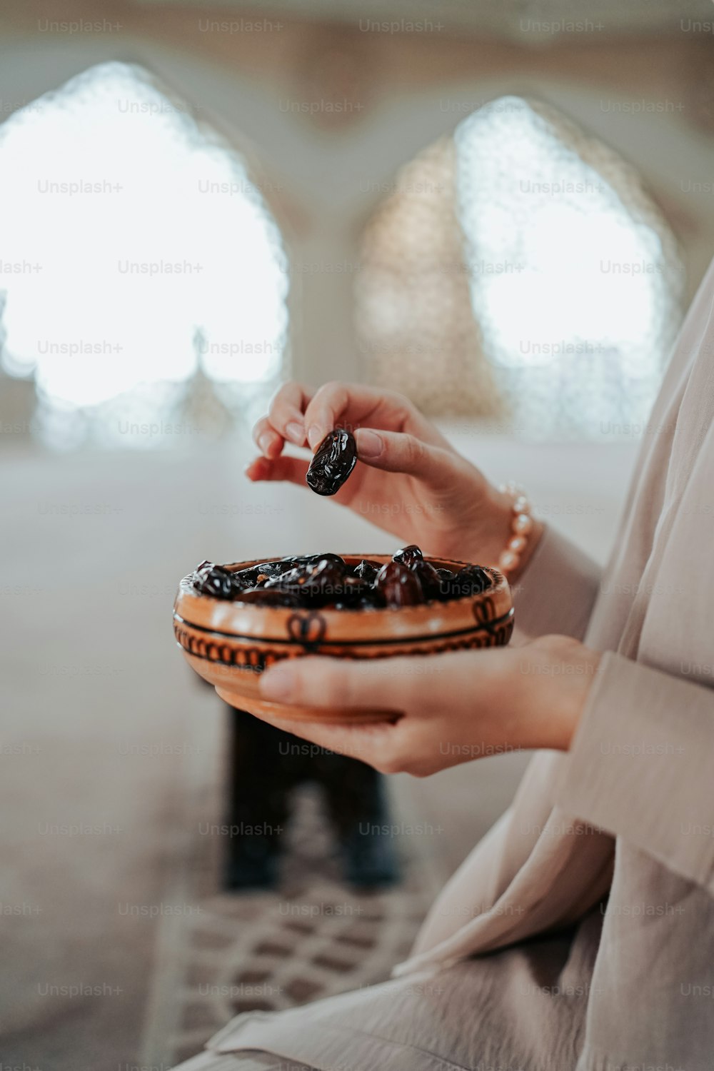 a woman holding a pastry in her hands