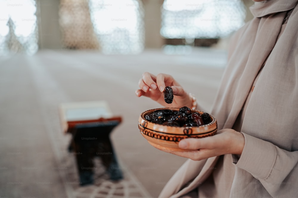 a woman holding a bowl of food in her hands