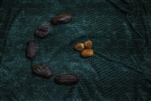 a group of nuts sitting on top of a green blanket