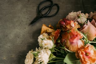 a bunch of flowers sitting next to a pair of scissors