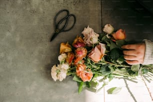a bunch of flowers and a pair of scissors