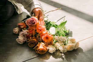 a person is arranging flowers on the floor
