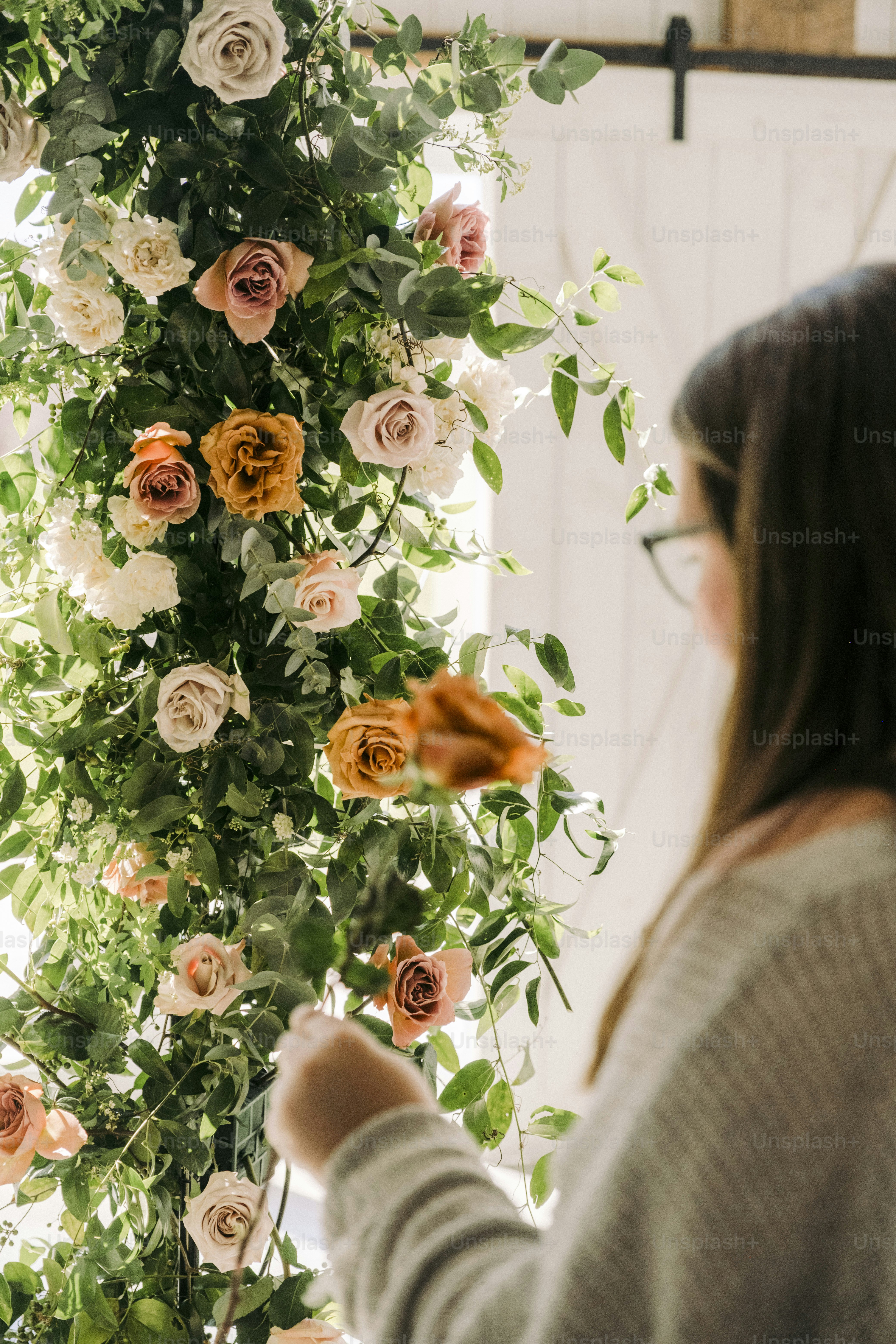 a woman standing in front of a flower display
