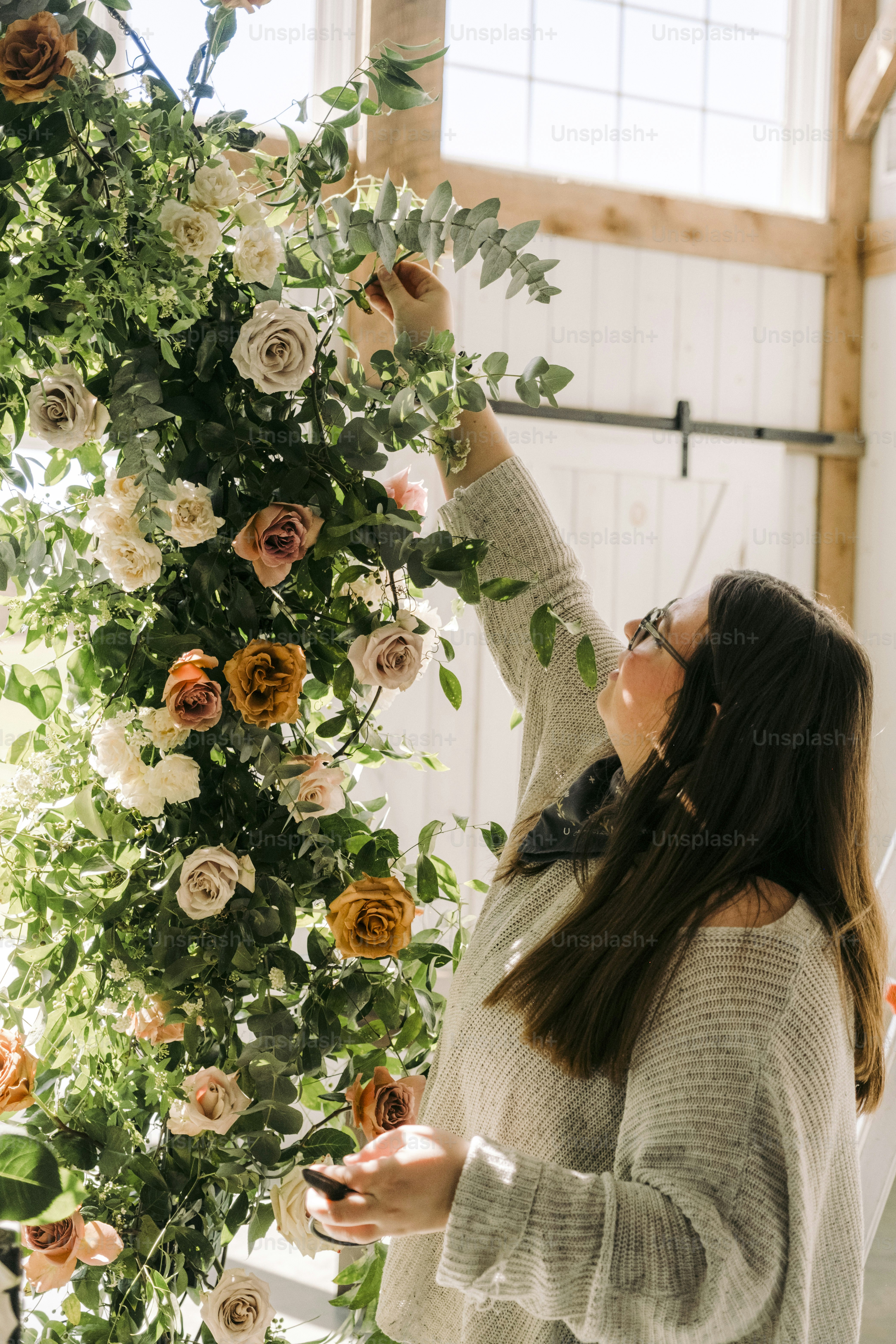 a woman arranging flowers in a room