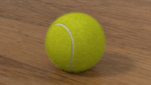 a close up of a tennis ball on a wooden surface