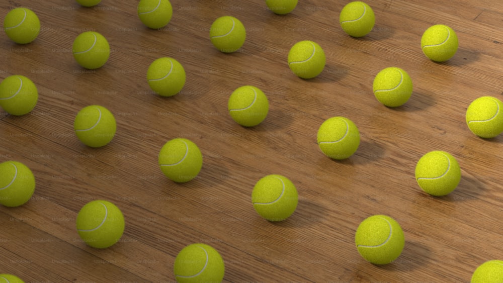 a group of tennis balls sitting on top of a wooden floor