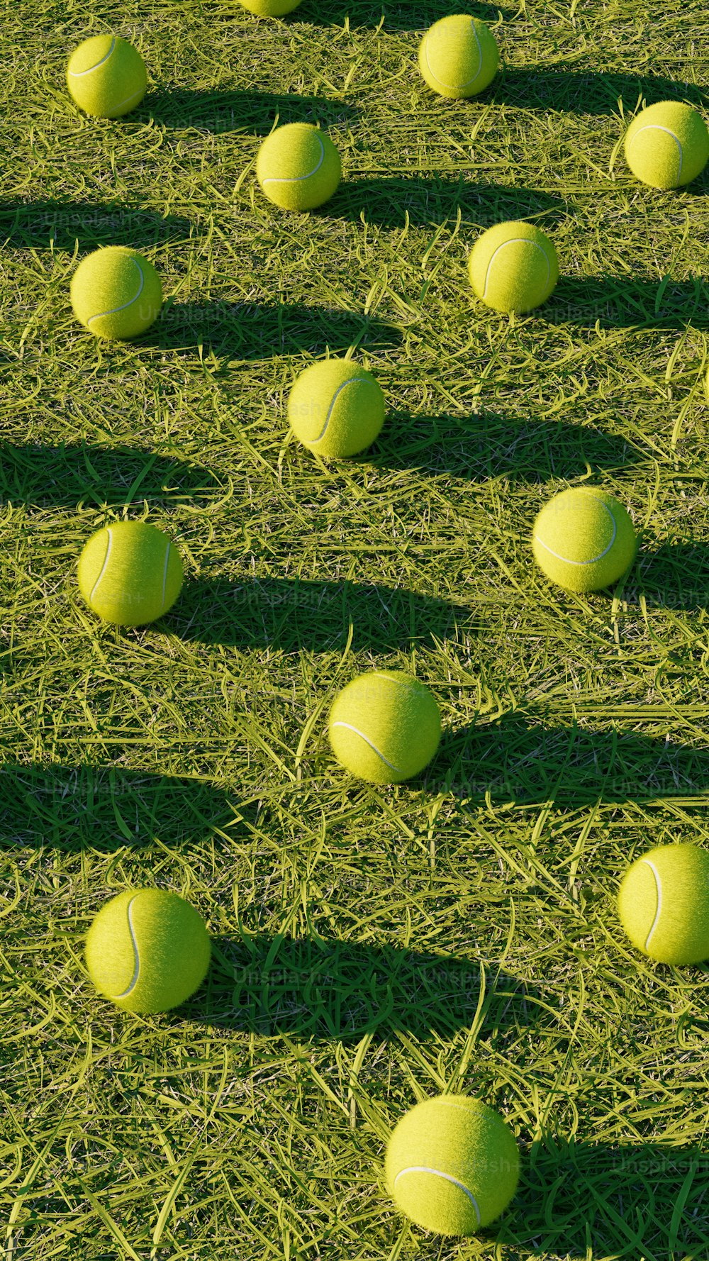 a group of tennis balls sitting on top of a grass covered field