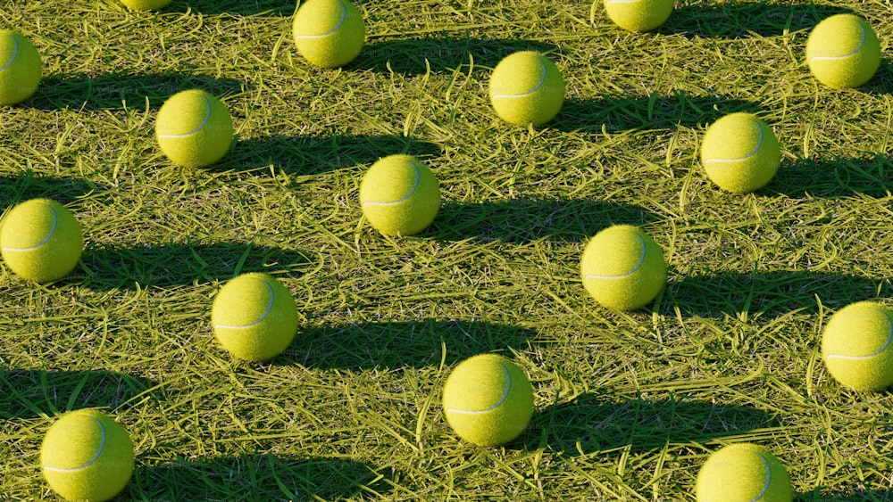 a group of tennis balls sitting on top of a grass covered field