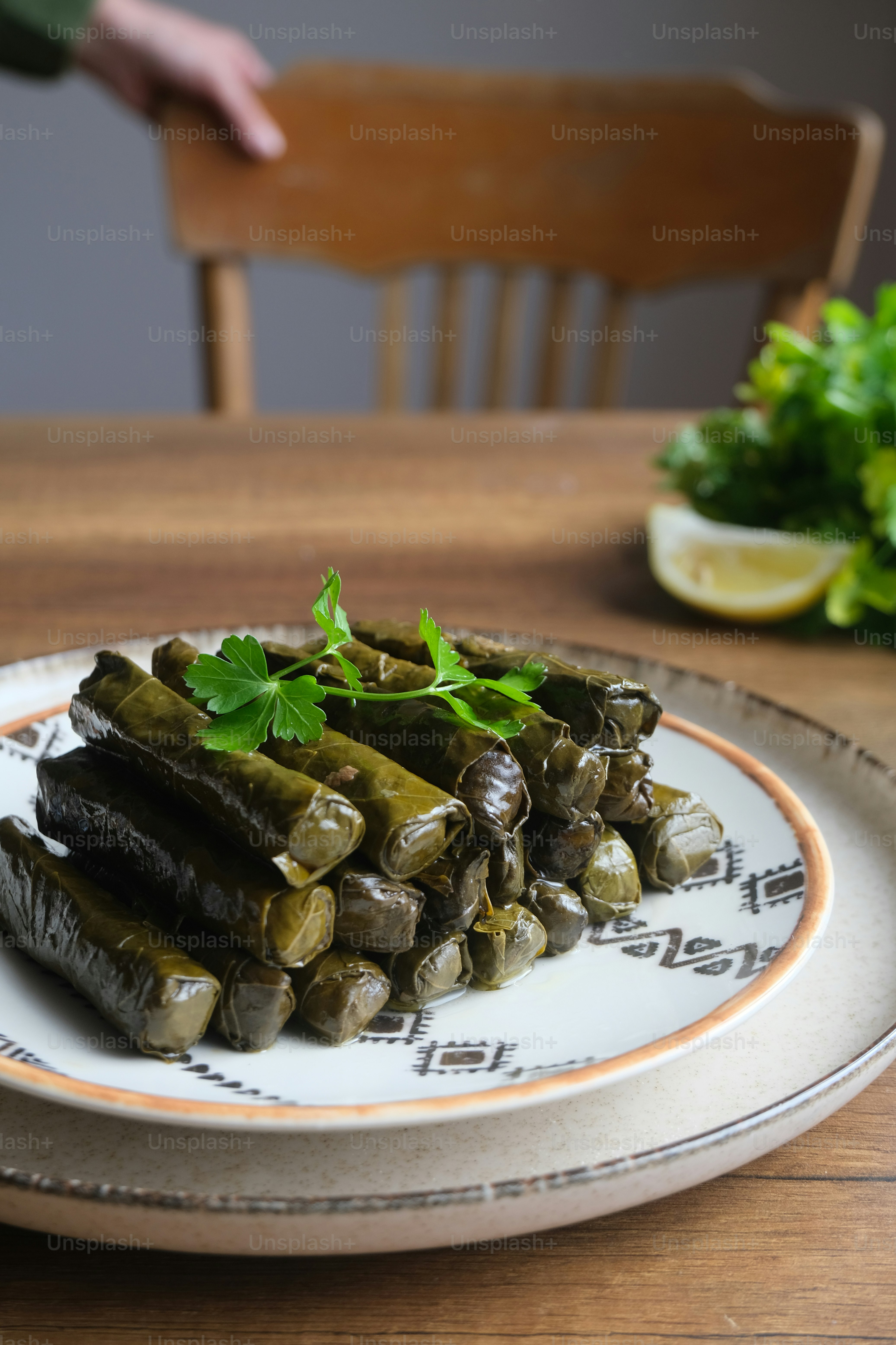 a white plate topped with green vegetables on top of a wooden table