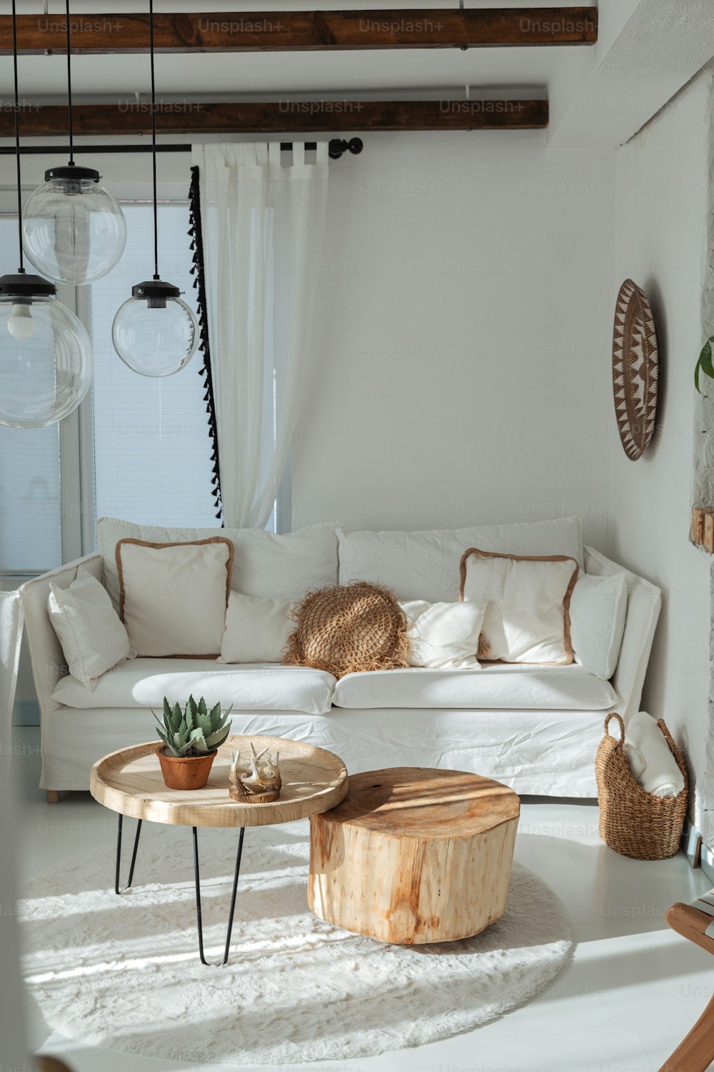 a living room with a white couch and a wooden table