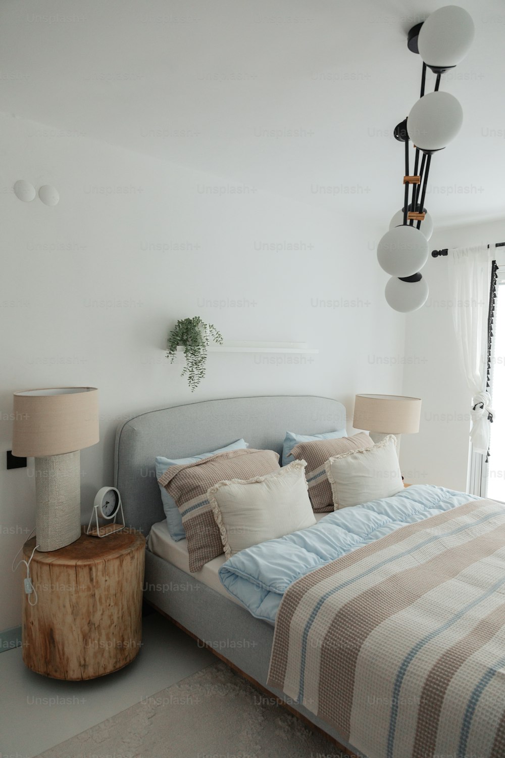 a bedroom with a bed, nightstand, and lamp