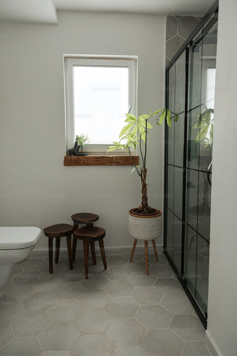 a bathroom with a toilet and a window