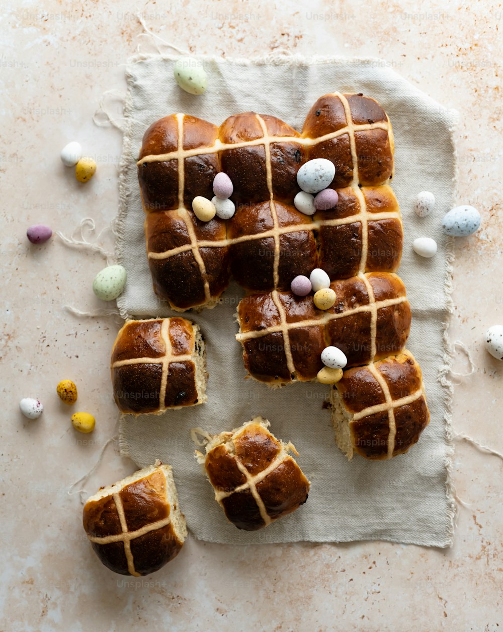a hot cross bun with easter candies on top of it