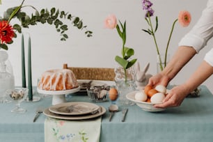 a person is decorating a table with flowers