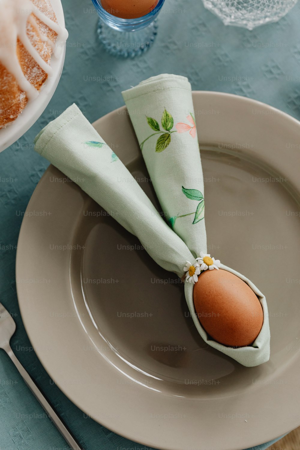 an egg on a napkin on a plate