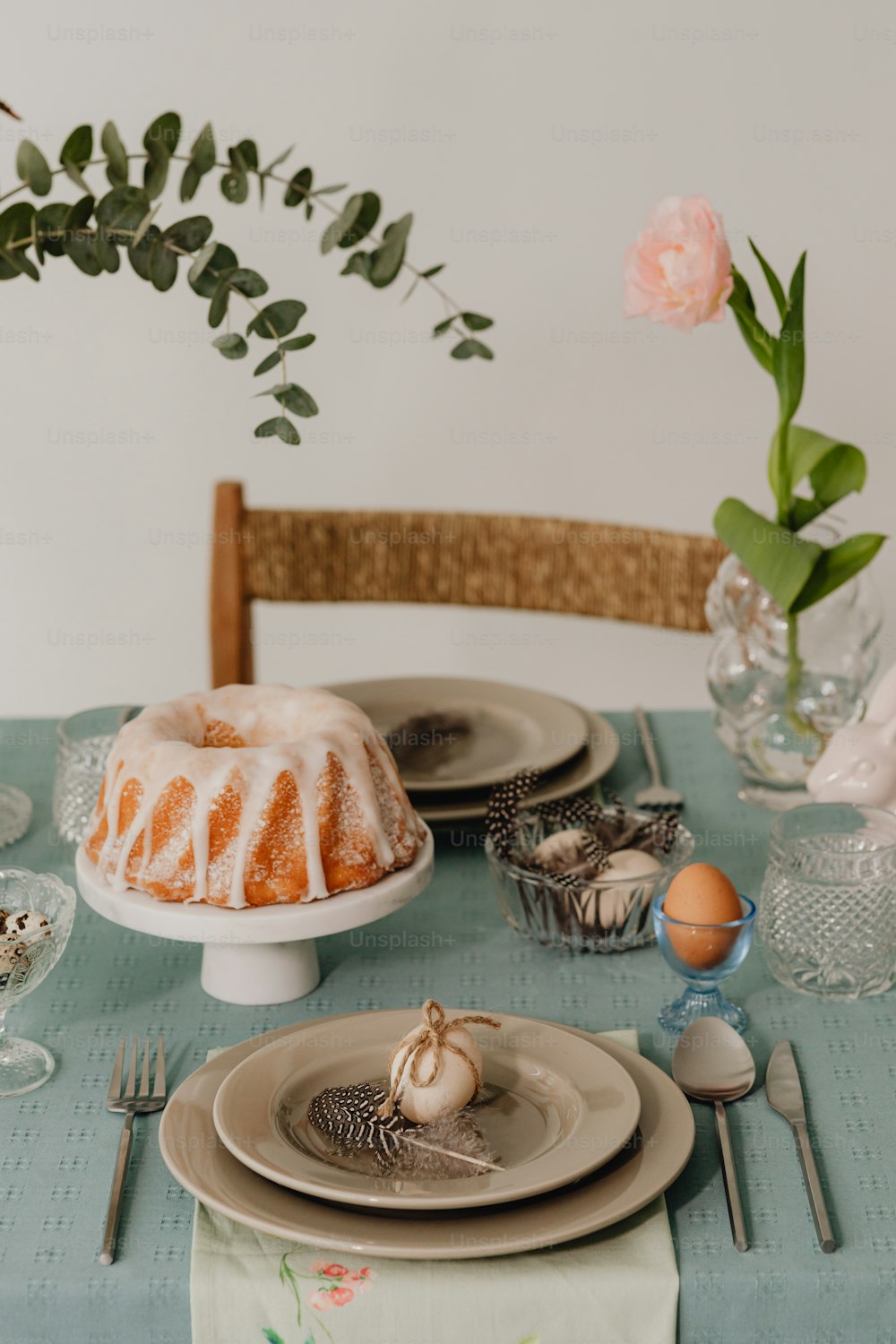 a table topped with a bundt cake covered in icing