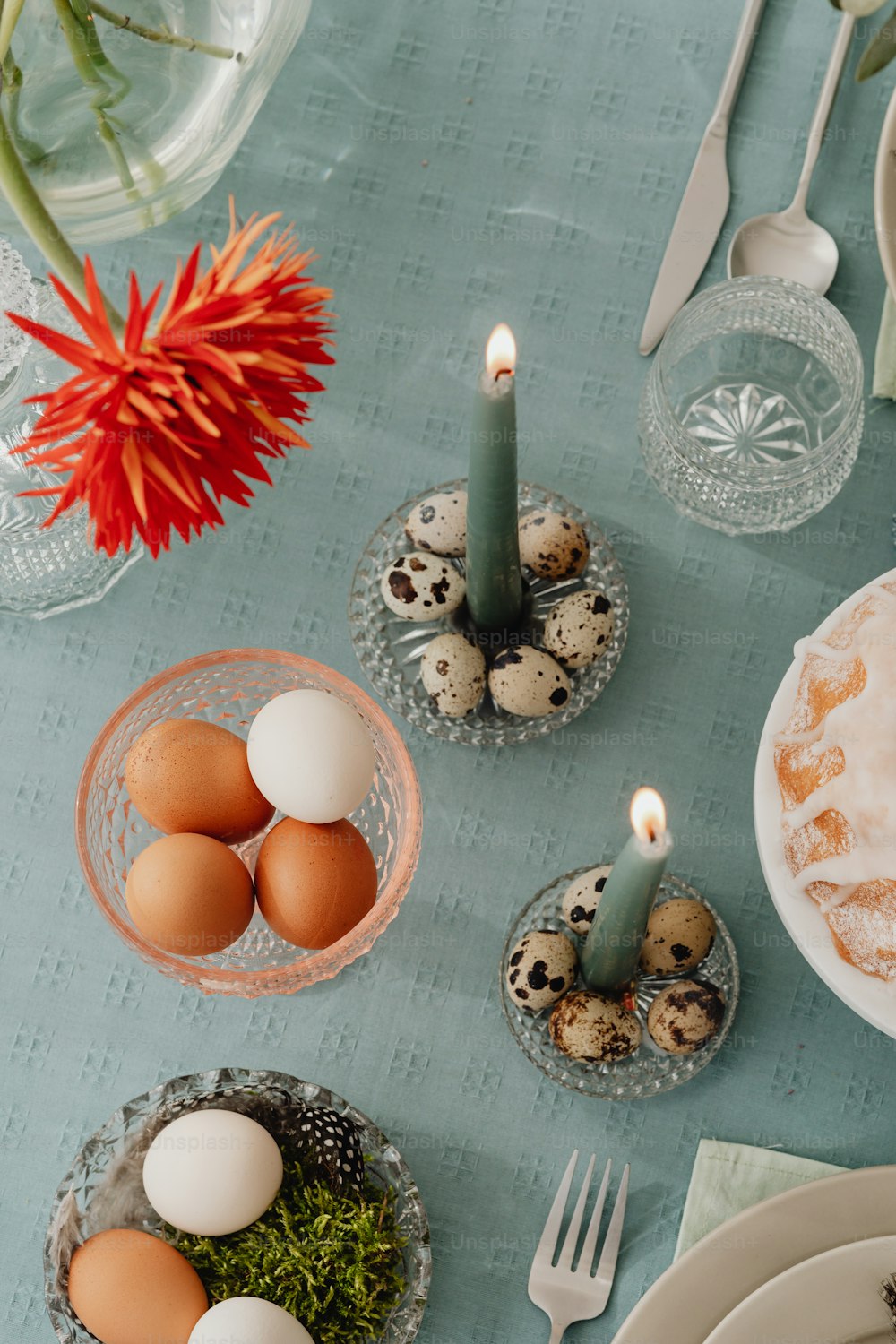 a table topped with eggs and a candle