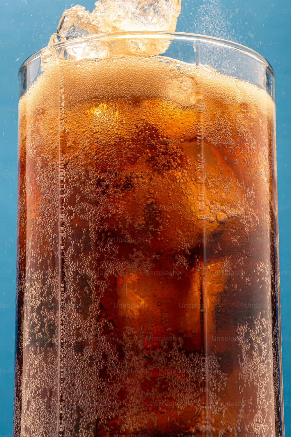 a close up of a glass of beer with ice