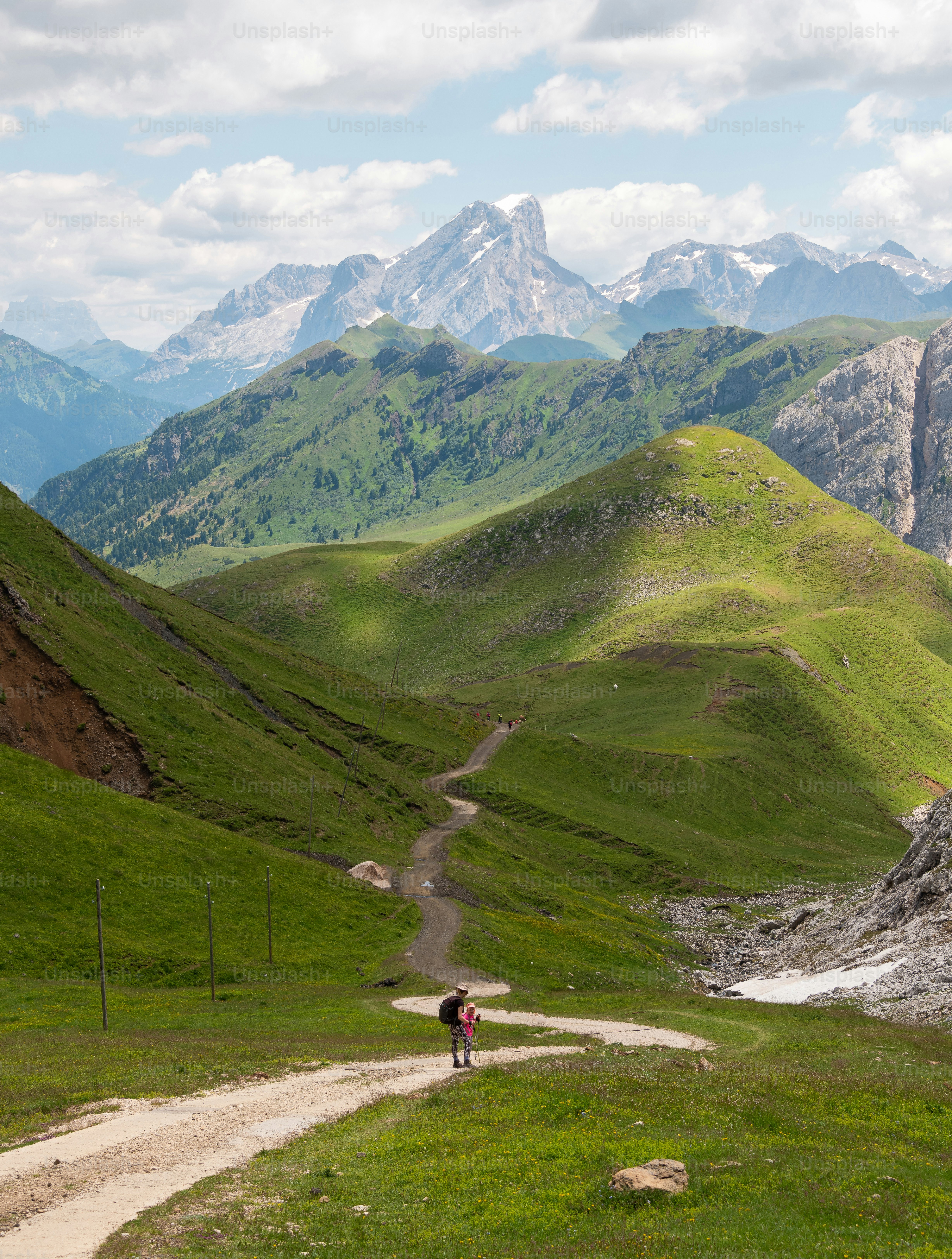 a person walking up a trail in the mountains