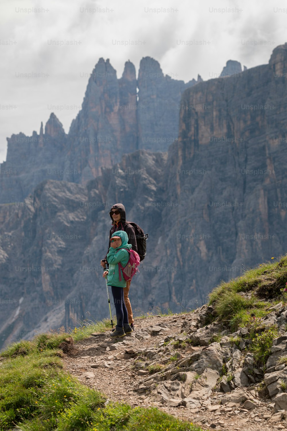 a man and a child on a mountain trail