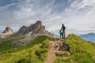 a couple of people standing on top of a lush green hillside