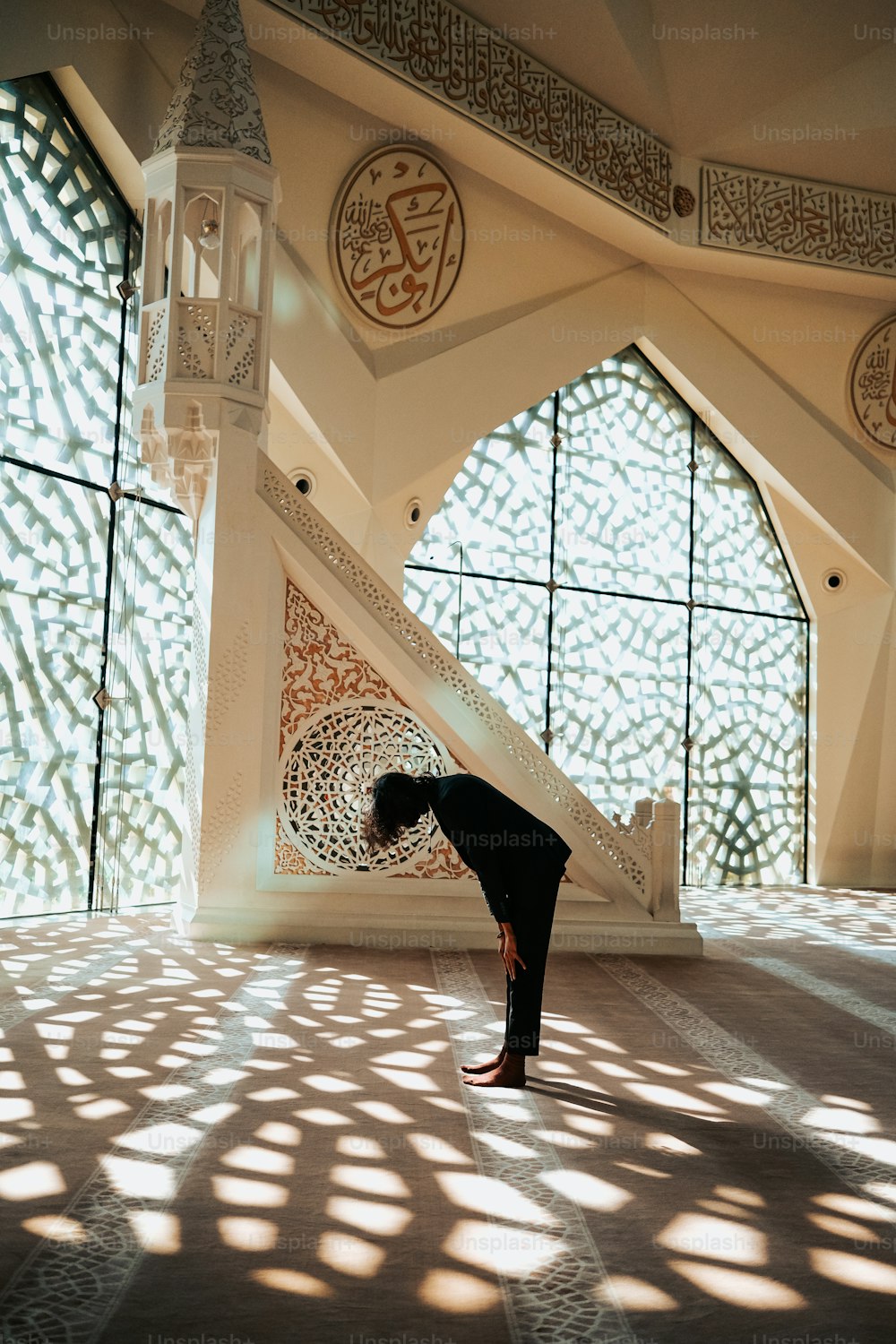 a person doing a yoga pose in front of a window