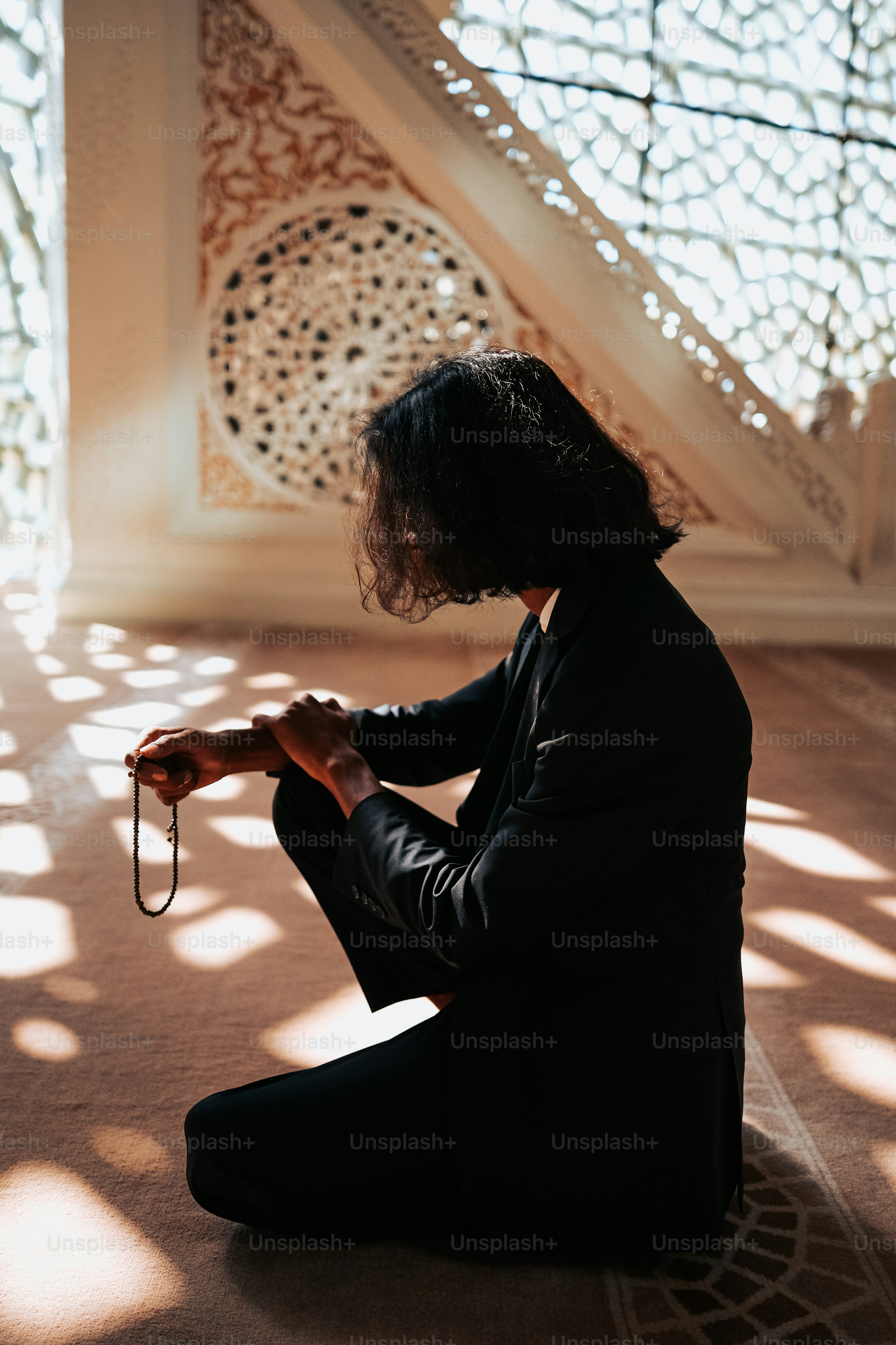 a woman sitting on the floor holding a pair of scissors