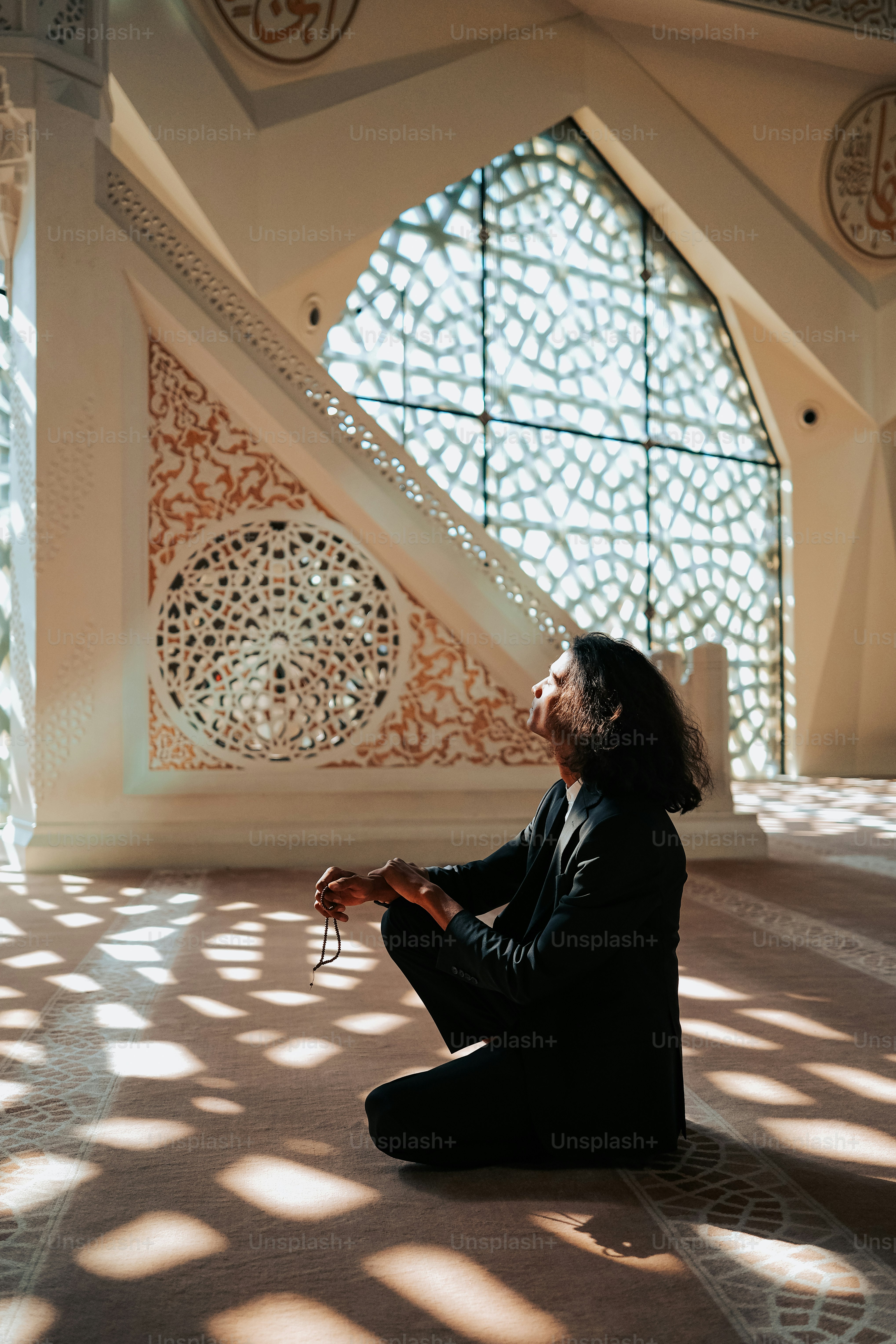 a man sitting on the floor in front of a window
