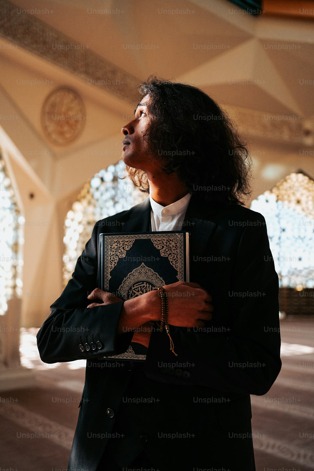 a man in a suit holding a book