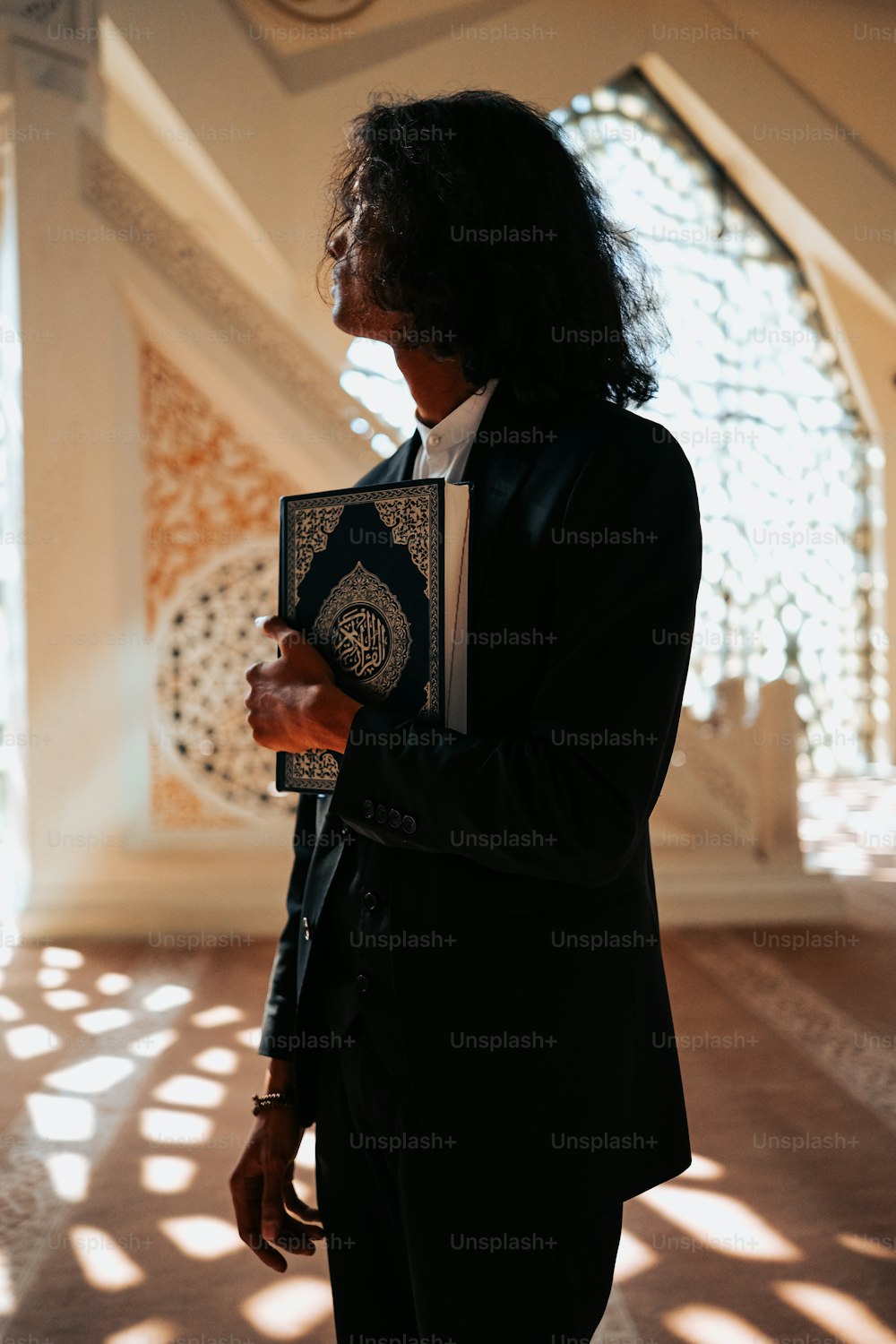 a man in a suit holding a book