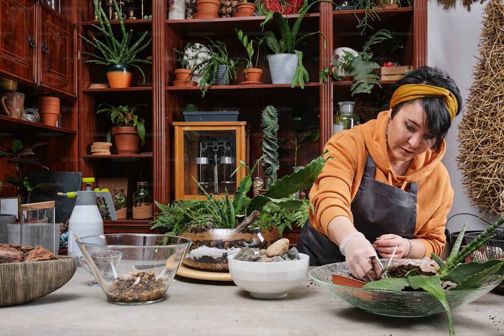 a woman in an orange shirt is preparing food