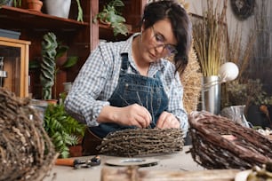 a woman is working on a bird nest