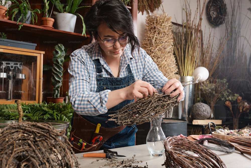 a woman working on a piece of driftwood