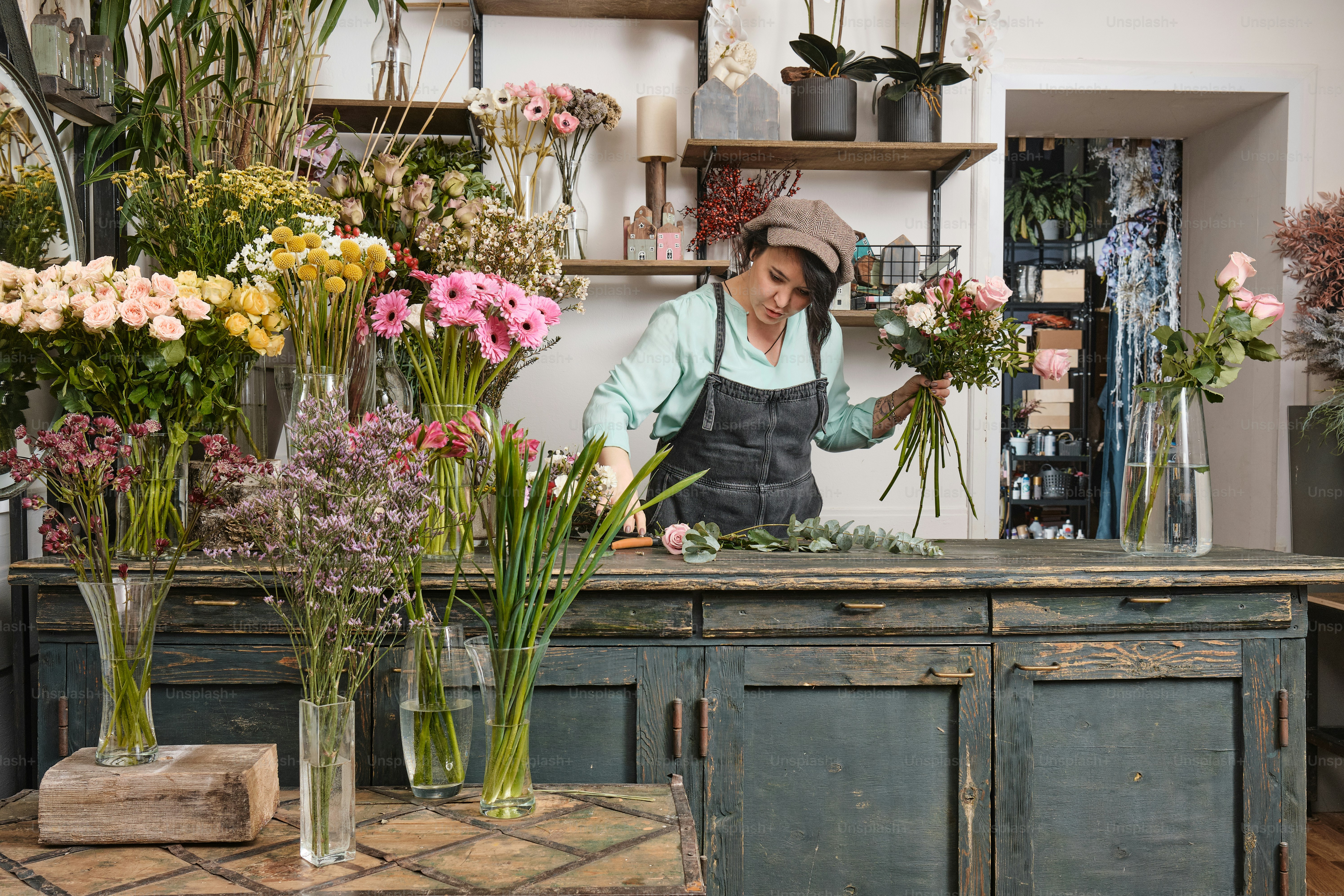 a woman arranging flowers in a flower shop