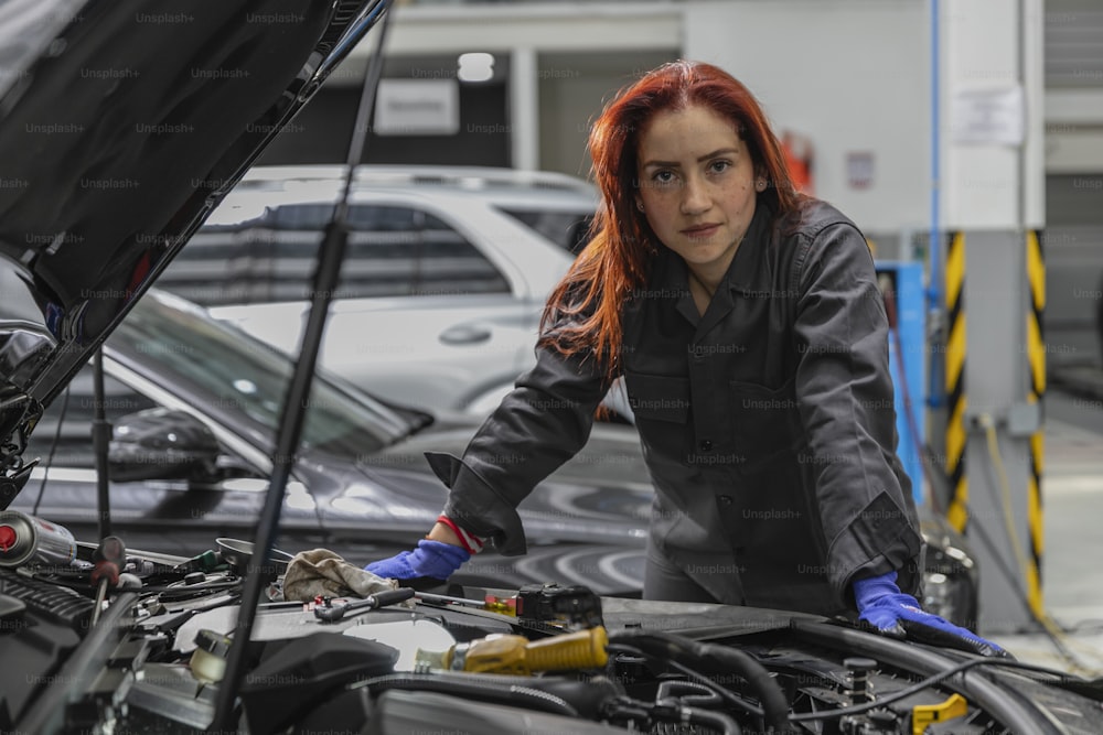 a woman working on a car in a garage