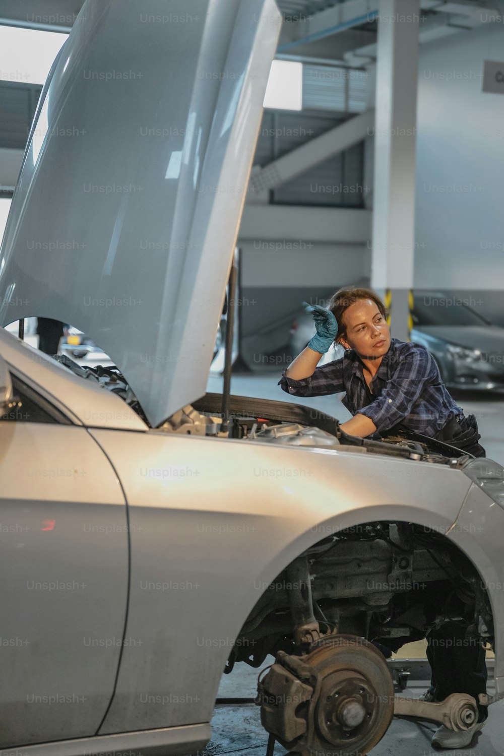 a man working on a car in a garage