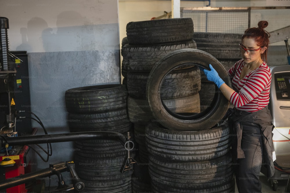 a woman working on a tire in a garage