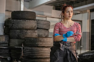 a woman in a red and white striped shirt and blue gloves