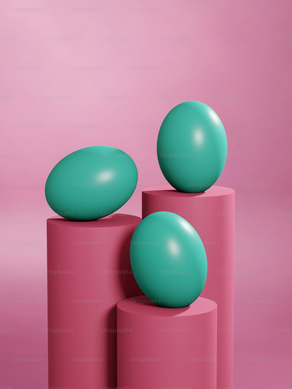 a couple of balls sitting on top of some pink cylinders
