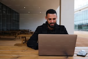 a man sitting in front of a laptop computer