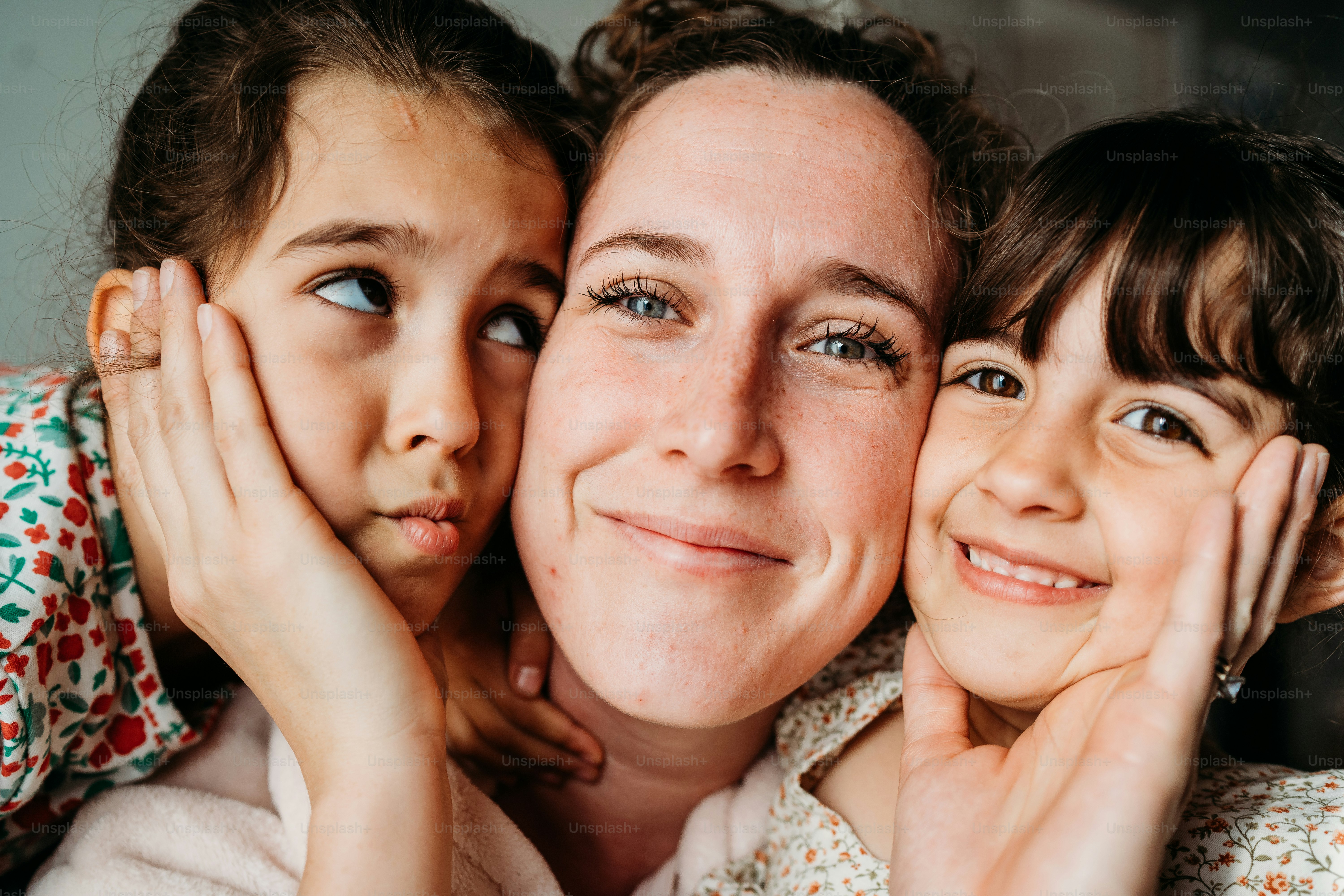a woman and two young girls posing for a picture