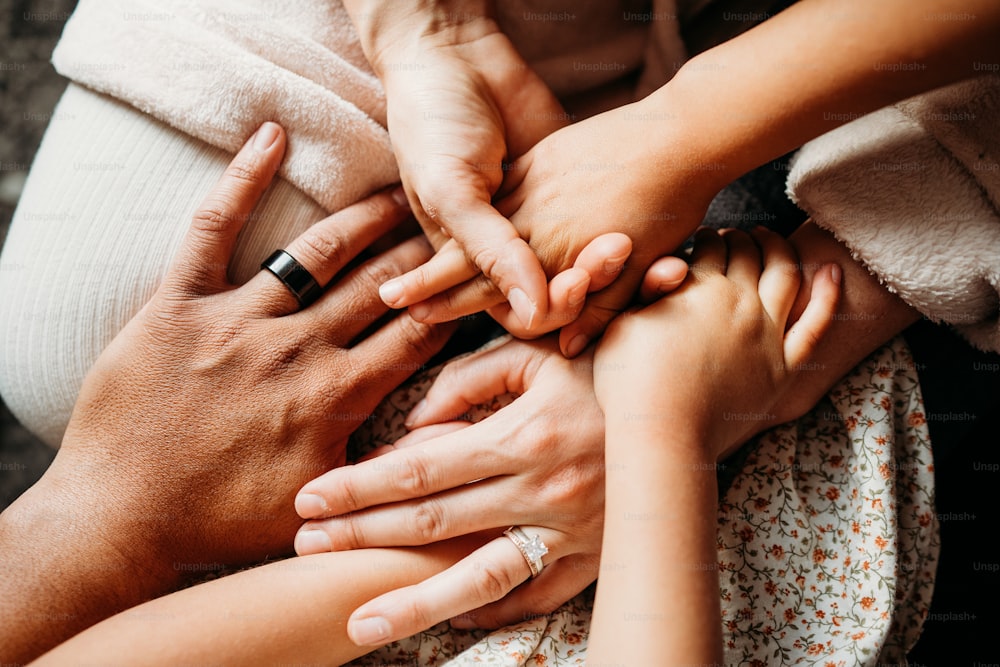 a group of people putting their hands together